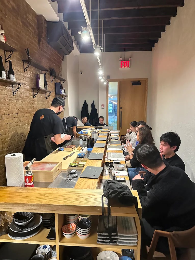 Hinoki counter and brick wall inside Kaiyo Omakase